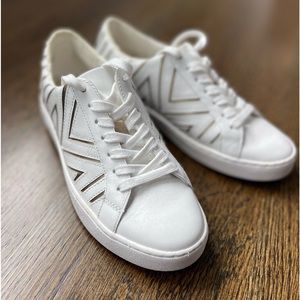 Micheal Kors sneakers white with gold detail.
